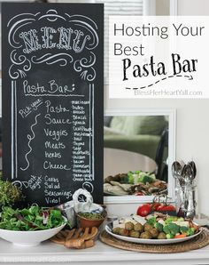 a table topped with plates of food next to a chalkboard sign that says menu