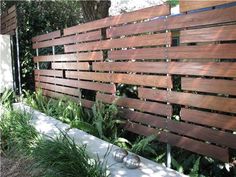 a wooden fence in front of a house