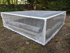 a large plastic box sitting in the middle of a field