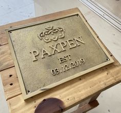 a wooden bench with a sign that says paxpen est 05 12 19