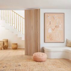 a living room filled with furniture and a painting on the wall