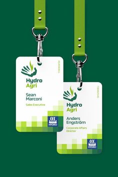 two luggage tags with green straps attached to each other on a green and white background