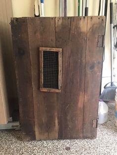 an old wooden box with a window in it