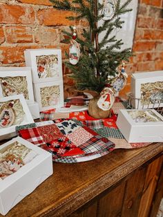 a christmas tree sits on top of a table with many cards and ornaments around it