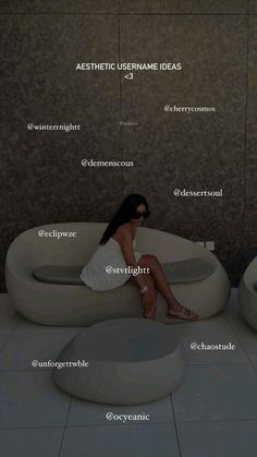 a woman sitting on top of a white couch in front of a wall with names