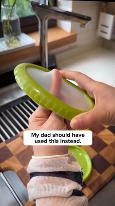 a person holding a green object in their hand with the caption my dad should have used this instead