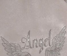 an angel tattoo on the side of a jacket