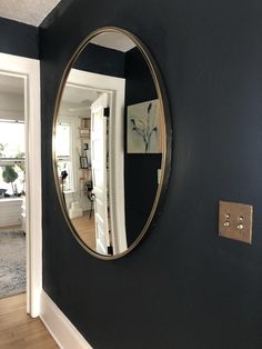 there is a mirror on the wall in this room that has been painted black and gold