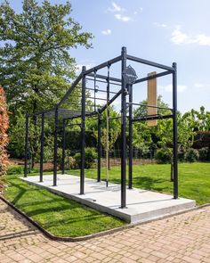 a metal structure sitting on top of a lush green field