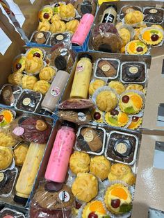 an assortment of pastries are displayed in boxes