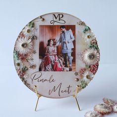 a personalized photo on a plate with flowers around it