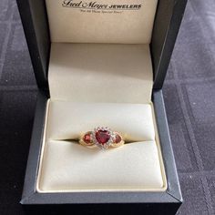 Beautifully Designed Ruby Ring With 3 Hearts With The Main Stone Surrounded In Diamonds. Ring Is 10k Gold And Size 7. Heart-shaped Yellow Gold Ruby Ring, Gold Heart-shaped 14k Gold Ruby Ring, Heart-shaped Ruby Ring With Diamonds As A Gift, Heart-shaped Ruby Ring For Valentine's Day, Heart-shaped 14k Gold Ruby Ring For Valentine's Day, Diamond Heart Ring, Ruby Ring, Diamond Heart, 10k Gold