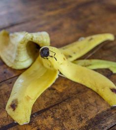 a peeled banana sitting on top of a wooden table