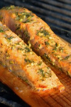 two pieces of meat are being cooked on a grill