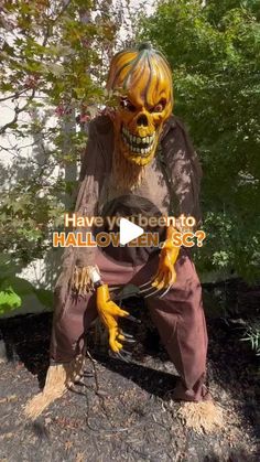 a creepy scarecrow sitting on top of a tree stump