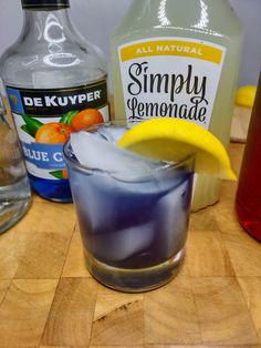 an alcoholic drink with lemon and blue custard