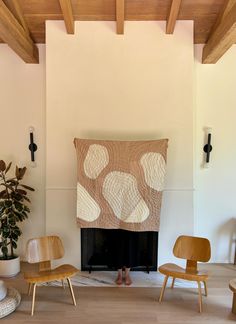 a living room filled with furniture and a fire place under a wooden ceiling mounted above a fireplace