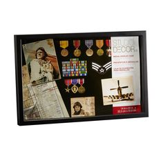 a black framed display with medals and photos on the front, along with an air force brochure