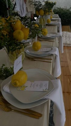 there are many plates with lemons on them and place cards in front of them