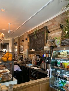 the inside of a bakery with lots of food and drinks on display in front of it