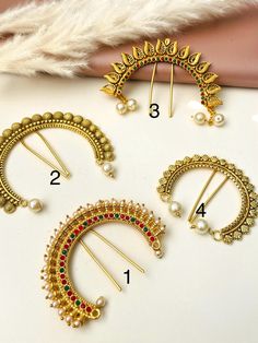 Maharashtrian khopa hair accessory.  This is traditional marathi air accessory that goes usually on hair bun .  4 options available, sizes are smaller to bigger .  Pattern 1 : antique gold plated , smallest in size .  Pattern 2: Yellow gold plated with Ruby , green and pearls .  Pattern 3 : Antique gold plated  Pattern 4 : Antique gold plated with danglers  Price is per piece. Jewelry Care: Avoid Contact With Perfumes, Sprays, Chemicals, and Water. Keep your Jewelry in a Clean, Dry, and Airtight Box. Wipe it using a Soft Cloth Regularly. Hair Accessories Traditional, Wedding Barrettes, Desi Style, Hair Bun, Gold Hair, Traditional Jewelry, Size Pattern, Wedding Hair Accessories, Barrettes