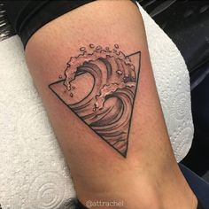 a black and white photo of a wave tattoo on the right side of the leg