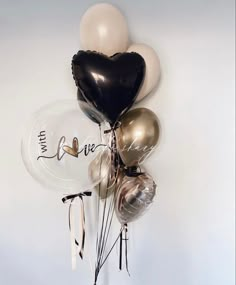 a bunch of balloons that say i love you and some are tied to the wall