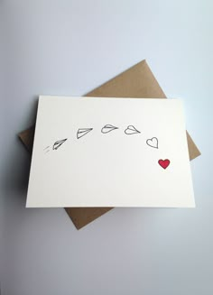 a card with hearts and arrows drawn on it