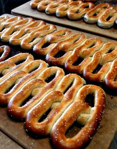 several large pretzels are lined up on the table and ready to be baked