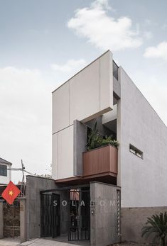 an apartment building with two balconies on the second floor