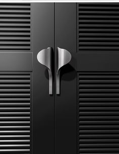 a black cabinet with two doors and a metal handle on the top one door is open