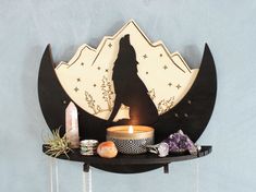 a candle and some rocks on a shelf