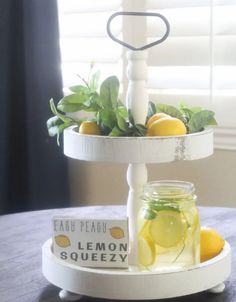 a table with lemons, lemonade and basil in mason jars on the tray