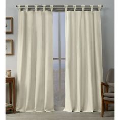 an open window with white curtains in it