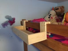 there are stuffed animals sitting on the bottom bunk