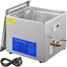 an electric deep fryer with the lid open and water running from it's side