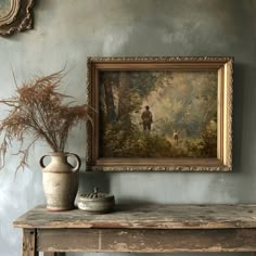 there is a painting on the wall next to a vase and an old fashioned urn