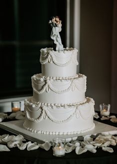 a white wedding cake sitting on top of a table