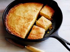 a skillet with some cut up pieces of cake in it