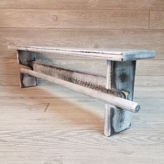 a wooden bench sitting on top of a hard wood floor