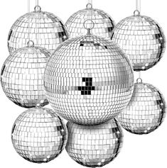 several shiny disco ball ornaments hanging from strings