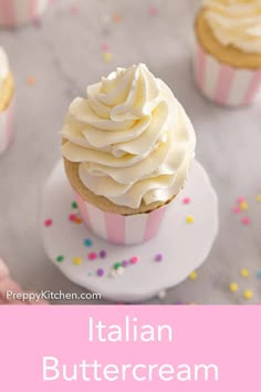 cupcakes with white frosting and sprinkles are on a plate