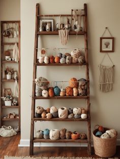 an old wooden ladder is filled with crochet balls and yarn in this living room