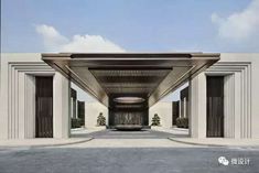 the entrance to an empty building with columns and doors on both sides, in front of a blue sky