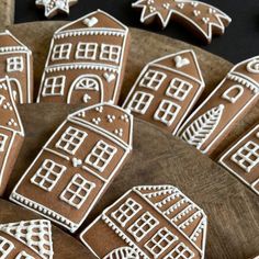 gingerbread cookies decorated with white icing on a wooden platter