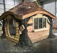 a house made out of logs and wood