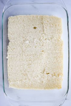 a square cake in a glass baking dish