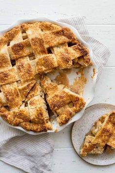 an apple pie on a plate with one slice cut out