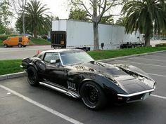 a black sports car parked in a parking lot