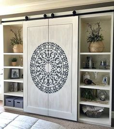 an open bookcase with two doors that have decorative designs on them